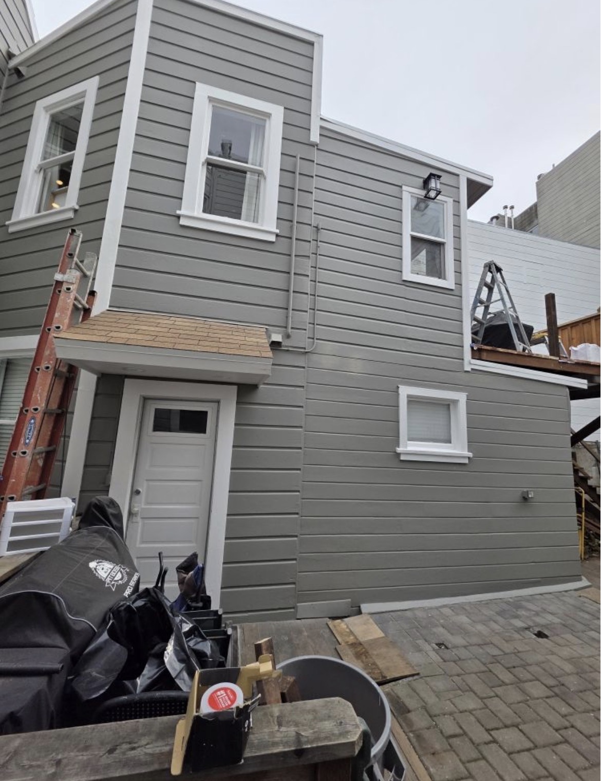 Rear of home — fresh gray siding & crisp white trim